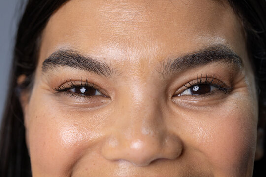African American female posing in studio, showcasing brows, mascara lashes, natural skin texture