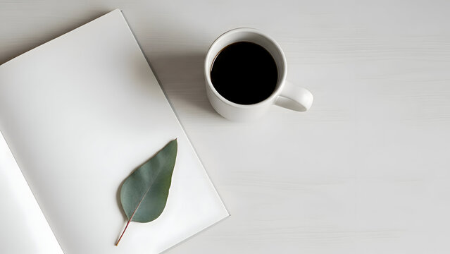 Minimalist workspace with coffee cup and notebook featuring a green leaf on a white background soft natural lighting