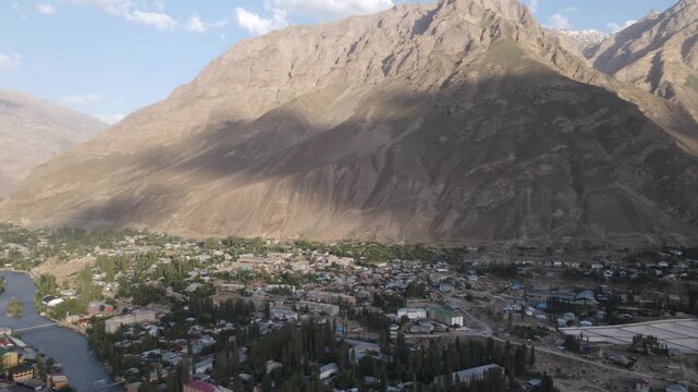 Aerial 180-degree panorama over Khorog, the Panj River and Afghanistan, surrounded by dramatic high mountains