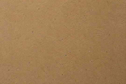 Close-up of a rustic brown kraft paper cardboard texture background