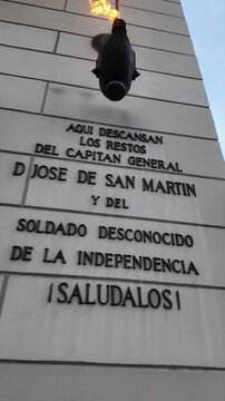 Detail of the burning votive flame and tribute plaque to San Martin on the facade of Buenos Aires Metropolitan Cathedral.