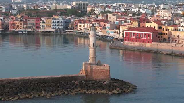  View of Chania with the amazing lighthouse, mosque, venetian shipyards, Crete, Greece.Waves crashing on lighthouse, Beautiful Greece and best scenic places - panorama