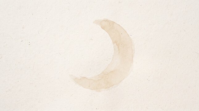 Crescent moon shaped coffee stain on white paper background