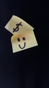 Yellow sticky notes with dollar sign and smiley face on black background