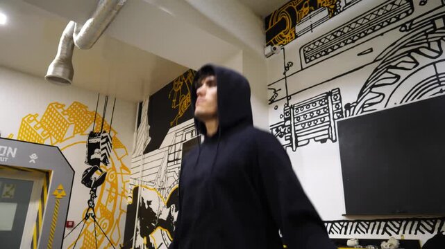 Young sportsman skipping with a jump rope at modern gym. Strong sporty man exercising in fitness centre. Athletic guy doing cardio at sport club. Concept of healthy and active lifestyle. Slow motion