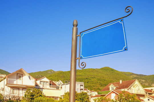 Empty blue pointer on street against sky. Montenegro, Tivat