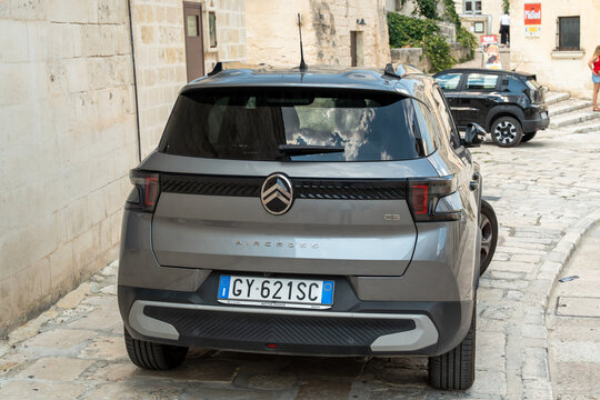 Matera, Italy - Aug 2, 2026: Grey Citroen C3 hatchback with an Italian license plate parked on a narrow cobblestone street in the Sassi district of Matera in Basilicata, rear view of the compact car 