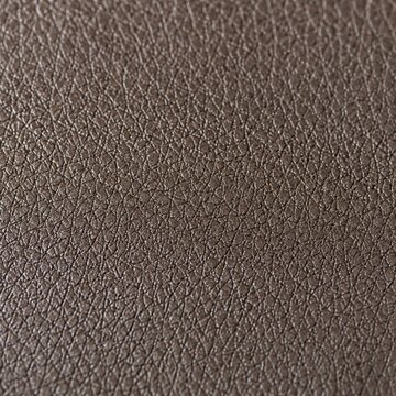 Close-up of dark brown leather texture with natural grain