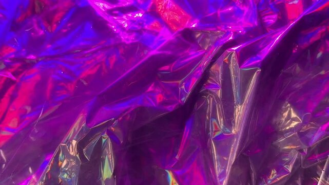 Iridescent crumpled foil material background