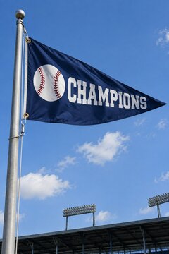 Baseball Champions pennant flag flying high on a flagpole against a blue sky, vertical