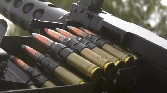 Large quantity of machine gun ammunition loaded into an ammunition box, prepared for military use. Ammunition, military equipment, armed conflict, and combat operations during the Russo-Ukrainian War