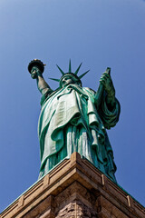 Majestic Statue of Liberty Against a Clear Blue Sky © MarekLuthardt