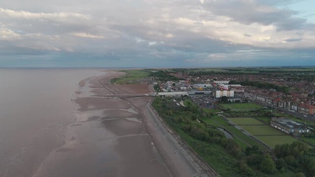 Aerial view of coastal town with wide sandy beach