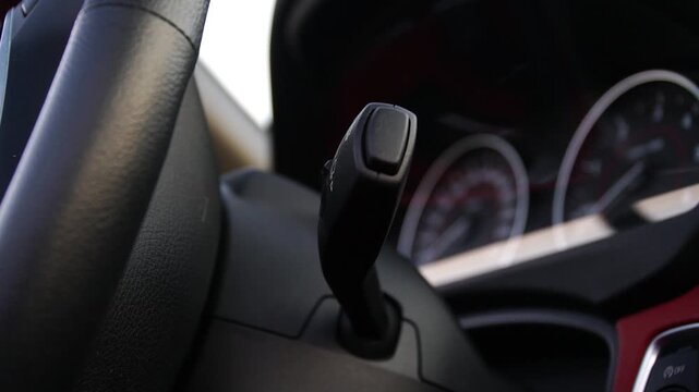 Close-up view of car gear shift lever in motion, showcasing gradual transition and intricate details of the dashboard, highlighting the dynamic driving experience and vehicle control