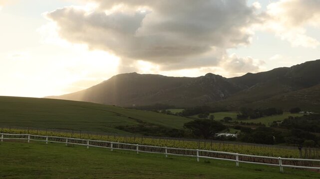shafts of light falling on Klein Mountains and rolling hillside, Stanford, South Africa