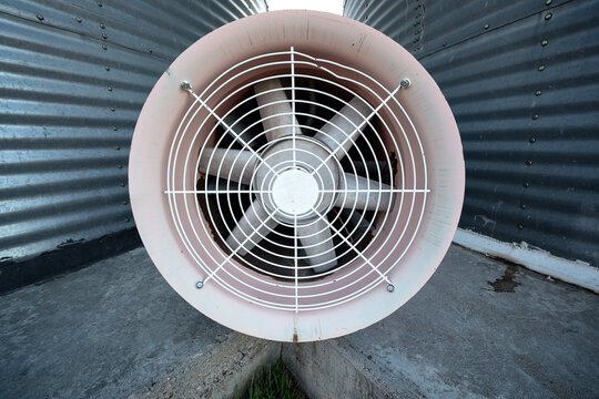 Close shot of fan between grain bins