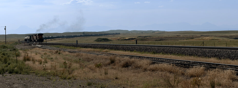 Xpan image of departing train in Montana landscape
