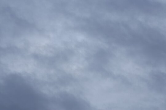 Full frame background of overcast cloudy sky with slate blue stratus clouds
