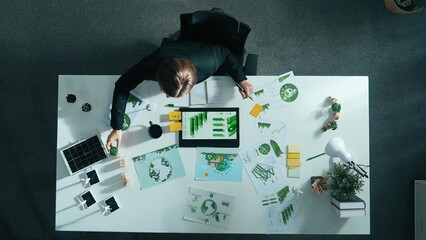 Obraz premium Time lapse of manager make decision about green business investment. Aerial view of professional business woman working at meeting table with document about green energy and zero waste. Alimentation.