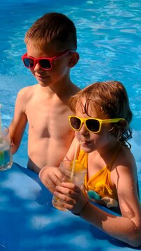 Children are swimming and playing in the pool. Selective focus.