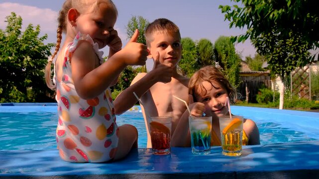 Children are swimming and playing in the pool. Selective focus.