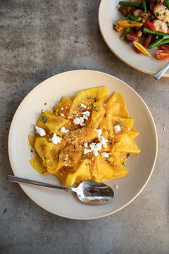 overhead shot of yellow beets topped with cheese at a farm to table restaurant