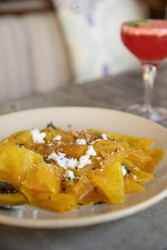 overhead shot of yellow beets topped with cheese at a farm to table restaurant