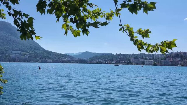 Lake Lugano and Monte Br&egrave; framed by trees in Lugano, Switzerland. 
