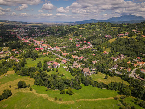 Bran village and green hills, Transylvania, Romania with Carpathian Mountains in background