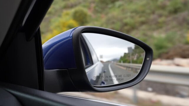 Slow Motion Driving Car On Mountain Road Seen Through Side Mirror