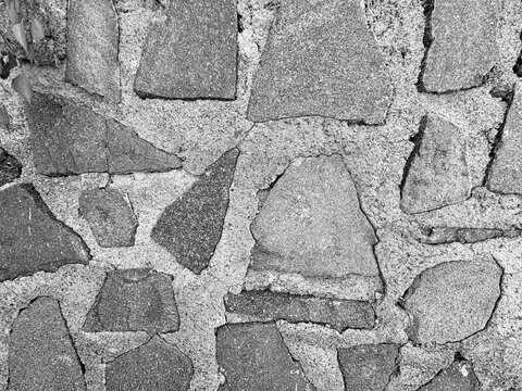 Black and white rustic stone wall texture close-up