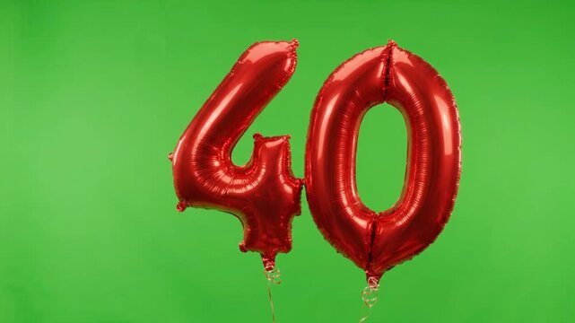 Red number 40 foil balloons on green screen, forty years anniversary celebration decor, ruby wedding anniversary party balloons