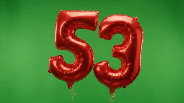 Red number 53 foil balloons on green screen background, fifty-three years anniversary celebration, metallic birthday party decorations