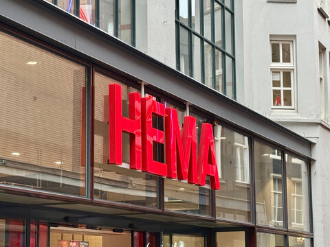 amsterdam, netherlands - July 31 2026: Bright red HEMA retail store sign mounted above large glass windows on a city building facade in the shopping area.