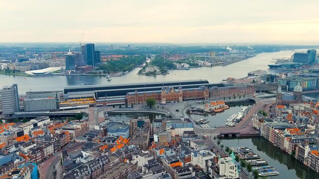 Amsterdam, Netherlands. Amsterdam Central Station. Amsterdam Centraal - The largest train station in the city, built in 1889. Bay IJ (Amsterdam). Drone footage, Point of interest