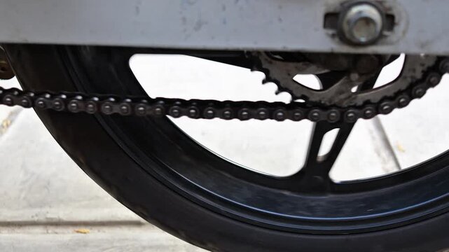 checking motorcycle drive chain slack and tension, vehicle maintenance and motorbike mechanical inspection concept.