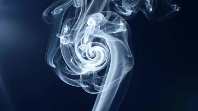 Wide shot of thin white smoke tendrils spiraling upward against deep