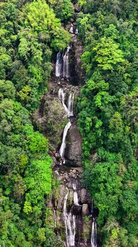Cinematic aerial drone footage of Shangliar Falls, a stunning multi-tiered cascading waterfall located in Meghalaya, Northeast India, near the Sylhet border of Bangladesh.