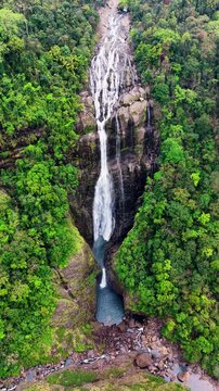 Cinematic aerial drone footage of Shangliar Falls, a stunning multi-tiered cascading waterfall located in Meghalaya, Northeast India, near the Sylhet border of Bangladesh.