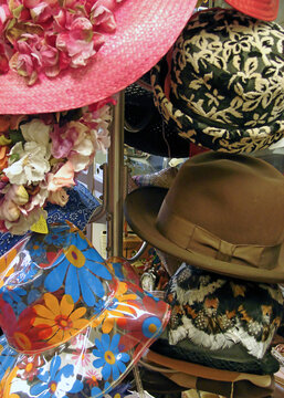 vintage hats on display on a hat rack in a secondhand store