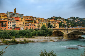 Fototapeta premium Colorful Mediterranean houses across Roya river in old town Ventimiglia, Italy