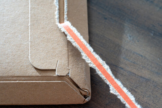 Close-Up Of Torn Tape On Cardboard Box