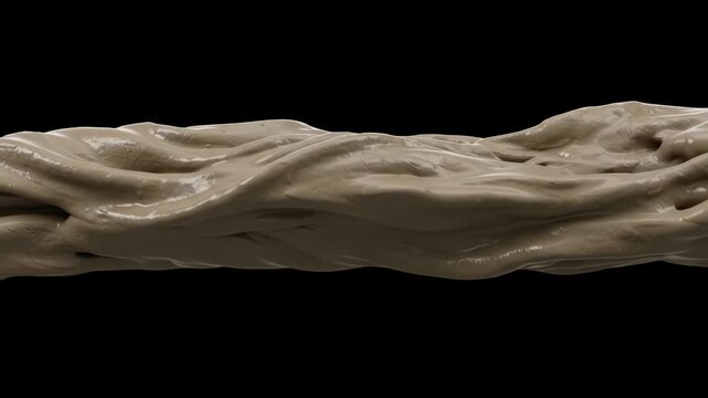 A thick stream of wet brown clay swirls smoothly in a horizontal line against a solid black background. Ideal for pottery arts, material science visuals, organic texture displays, and industrial motio