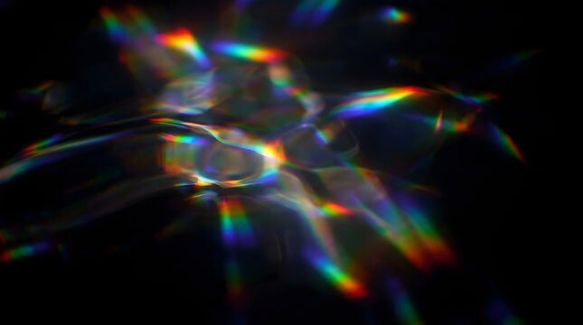 Abstract rainbow prism light refraction with colorful caustic patterns on black
