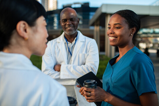 Doctors and nurse talking during coffee break outside hospital