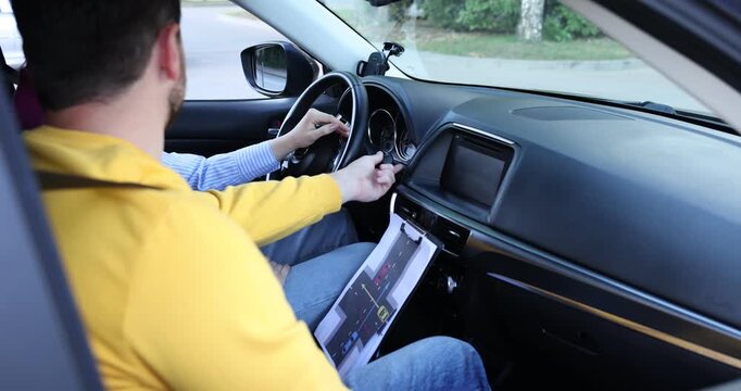 Driving school. Instructor showing student indicator stalk in car, closeup
