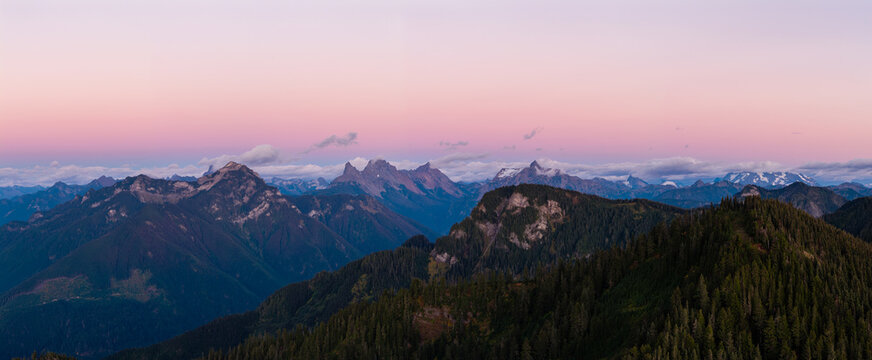 Pink Sunset Over Mountain Range Near Chilliwack BC Canada With Forested Peaks And Pastel Sky