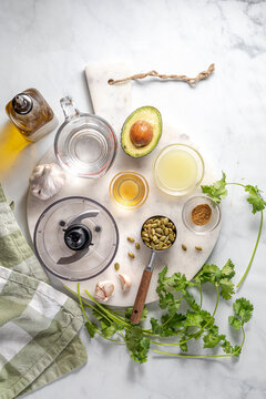 Ingredients on a marble cutting board used for making a salad dressing.