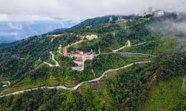 Aerial view of residential houses nestled in lush green hills