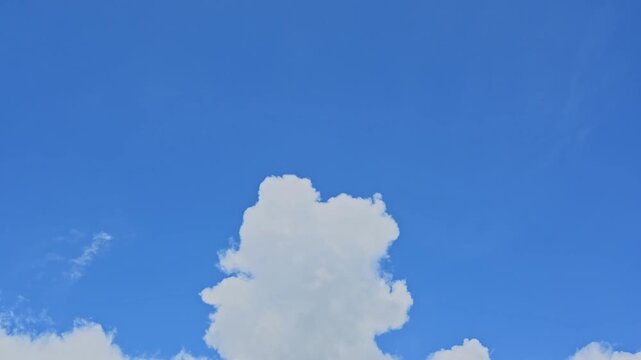 video timelapse 4k Beautiful Blue Sky with Fluffy White Clouds on a Bright Summer Day, Peaceful Cloudscape and Natural Atmosphere Background